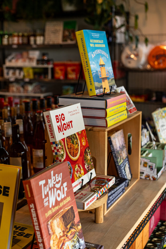 Cookbook display at Miss Market with shelves of specialty pantry goods