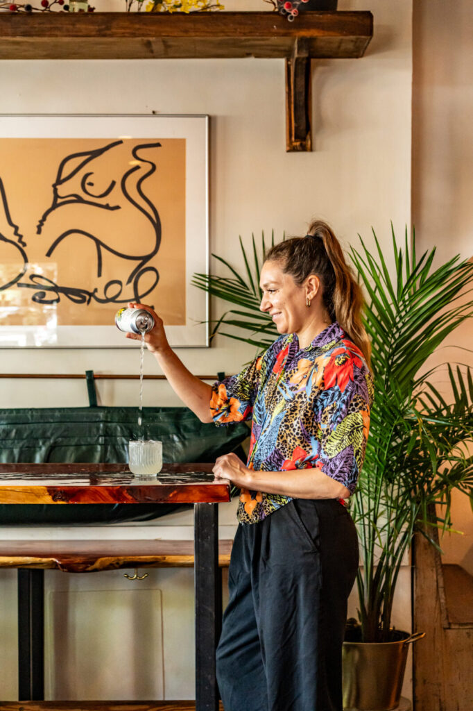 Vassiliki Ellwood Yiagazis, owner of Smoke & Honey, pouring a St. Rains at the bar