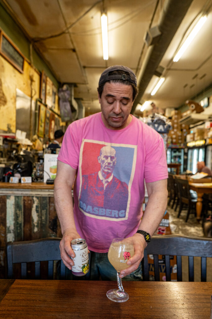 Dan Stein pouring a St. Rains Ojai Kush into a glass at Stein's Deli